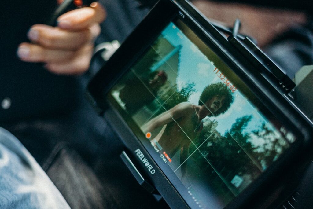 The Art of Drawing Readers In: Your attractive post title goes here Close-up of a cinematic display showing a filmmaker at work capturing a scene outdoors.